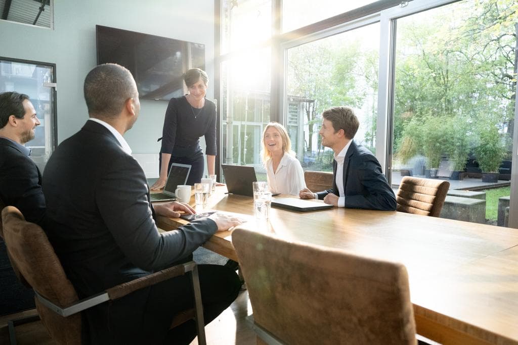 Trivyun HR consultants collaborating around a table during a client strategy session.